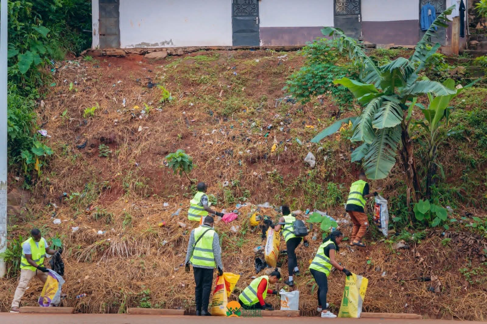 Volunteers collect discarded waste from a roadside area during the community clean-up.